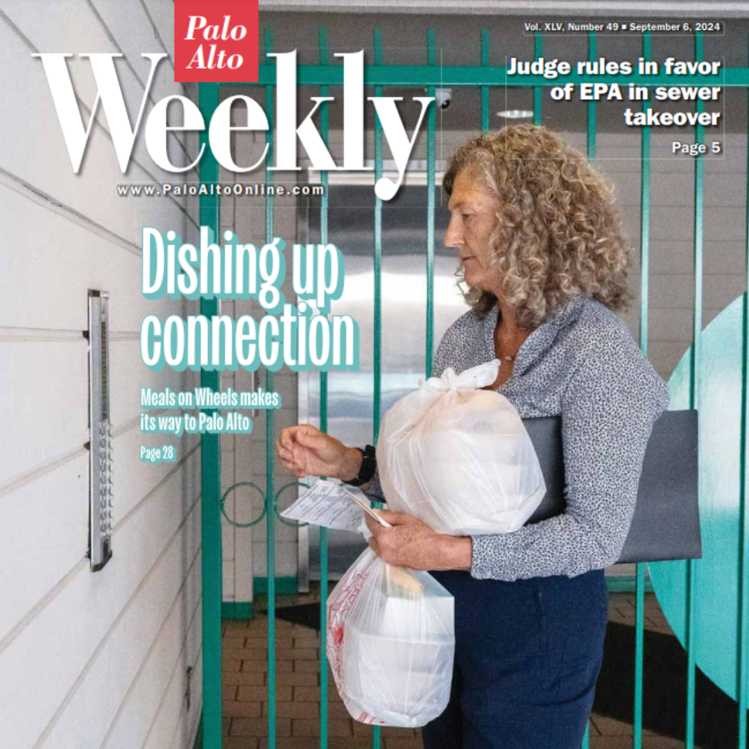 Stephanie Figeira's, PVI Director of Nutrition Services, holding two bags of food outside a client's residence for PVI Meals on Wheels.